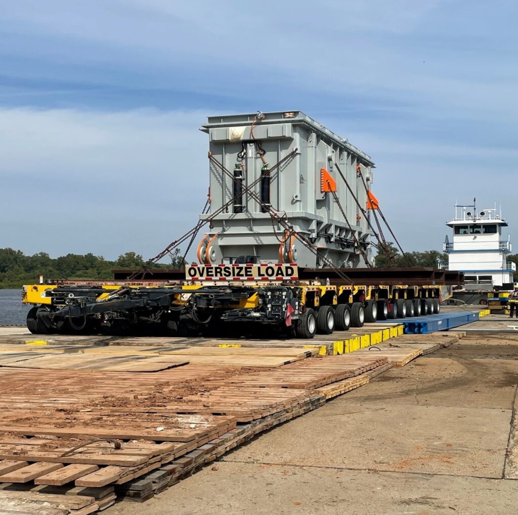 H. Brown, Inc. heavy hauling service unloading and transporting a transformer from a barge utilizing SPMTs.