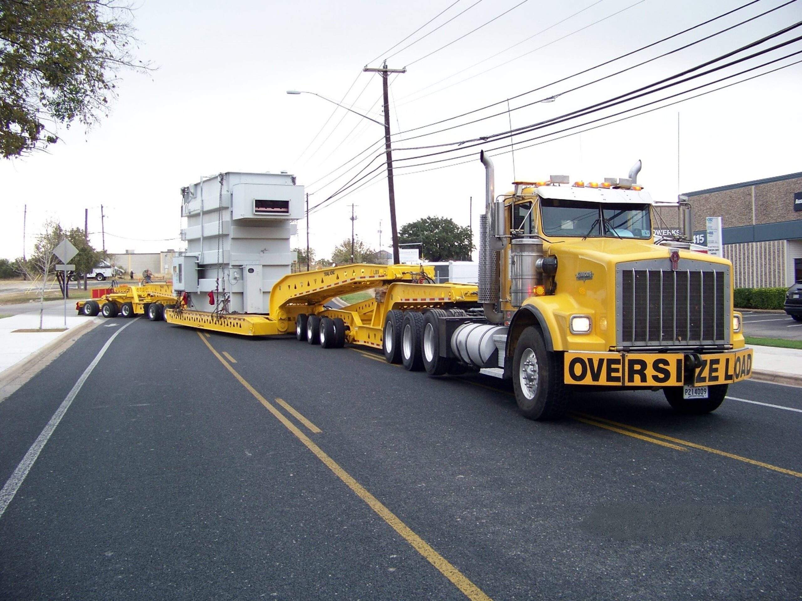 H. Brown, Inc. crane, rigging, and heavy hauling service transporting 150,000 lb. transformer in Austin, TX. Loaded, transported, and offloaded by H. Brown, Inc.