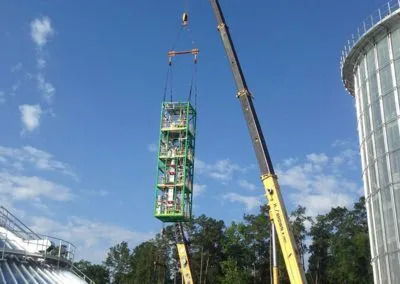 H. Brown, Inc. crane service mid lift and preparing to place processing equipment inside a silo.