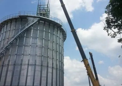 H. Brown, Inc. crane service mid lift and preparing to place processing equipment inside a silo.