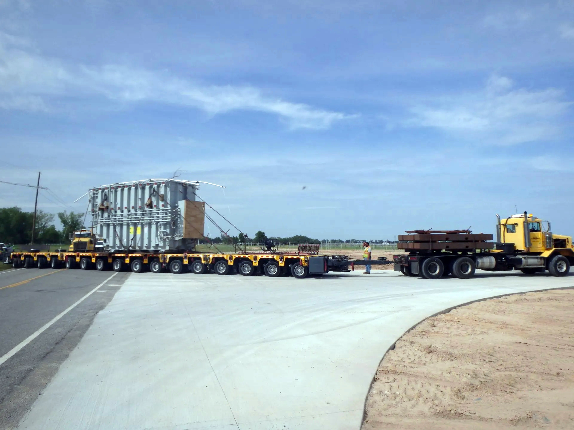 H. Brown, Inc. specialized transportation service making a turn with SPMTs hauling a transformer.