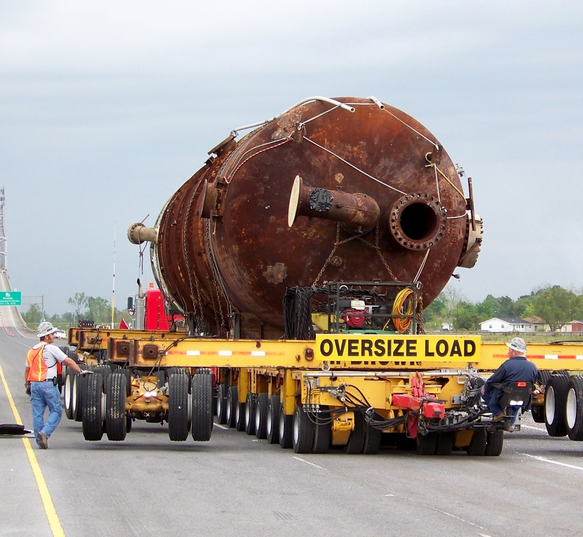 H. Brown, Inc. heavy hauling service transporting 330,000 lb. vessel from a plant to the Port of New Orleans utilizing beams and dollies to cross the Mississippi River.