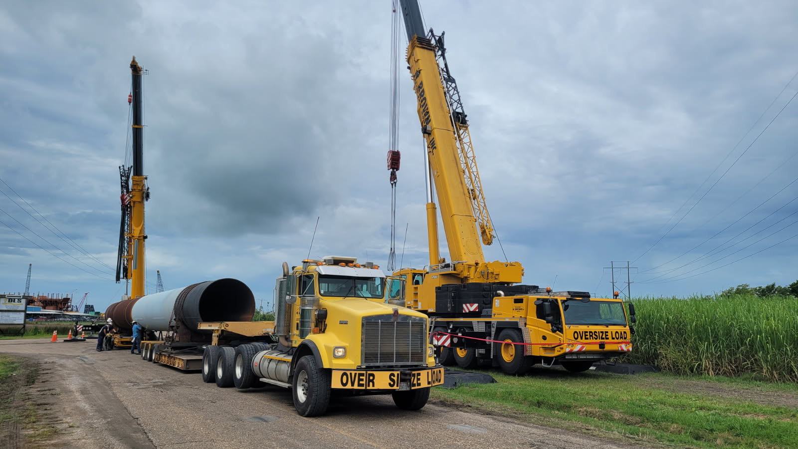 H. Brown, Inc. crane and heavy hauling service performing a dual lift to load and transport.