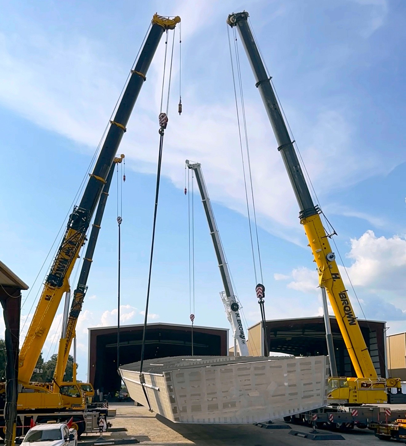 H. Brown, Inc. crane service performing a multi-crane lift using four cranes to flip a boat for a manufacturing facility near New Iberia, LA.