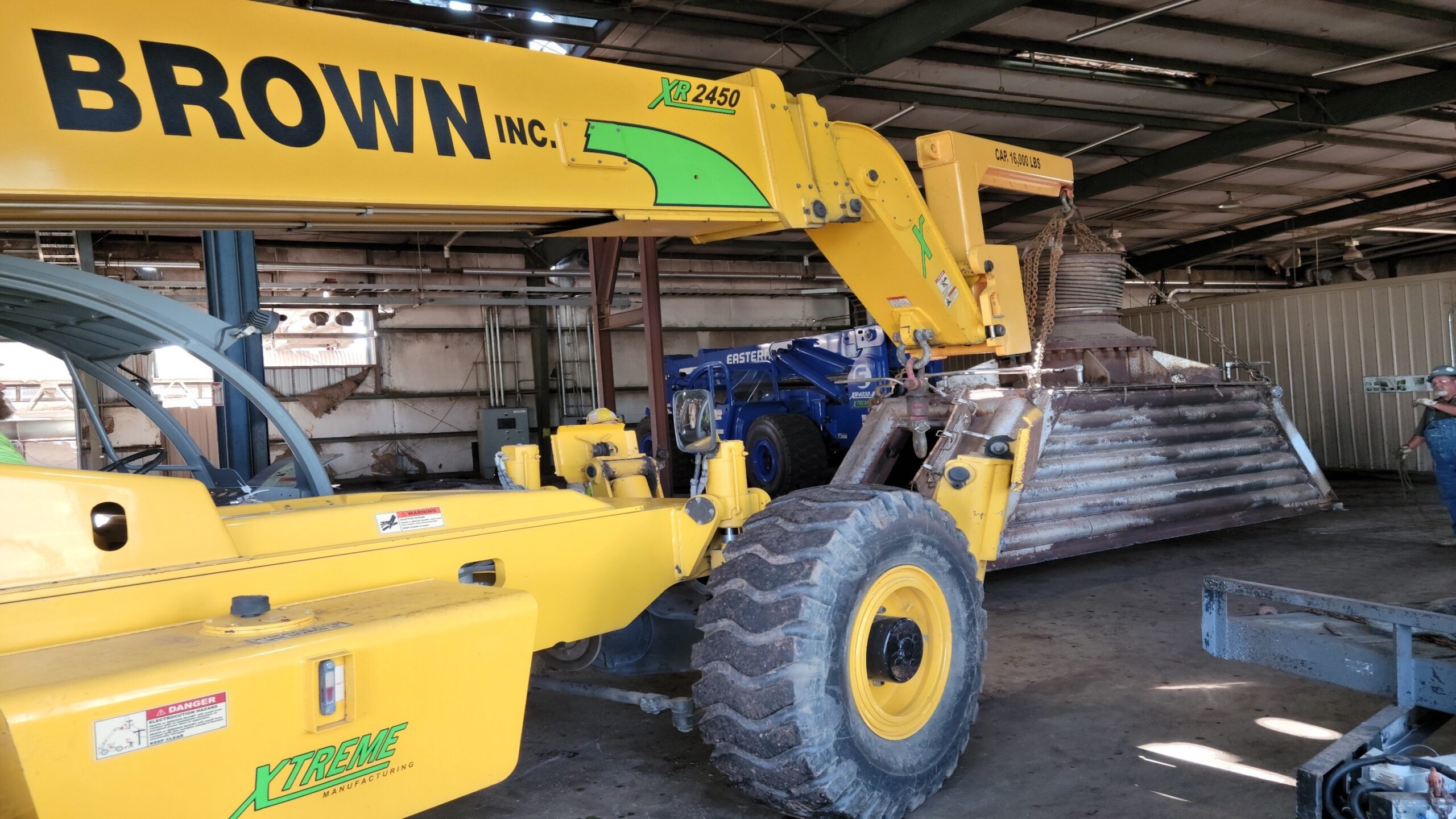 H. Brown, Inc. rigging service using a 24k lb. telehandler with jib attachment from a tight indoor space.