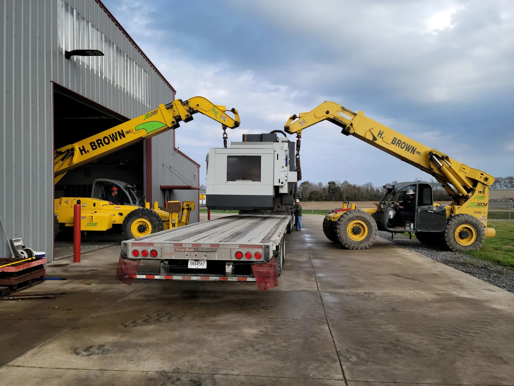 H. Brown, Inc. rigging service 24k lb. and 30k lb. capacity telehandlers performing a dual lift to remove and load.