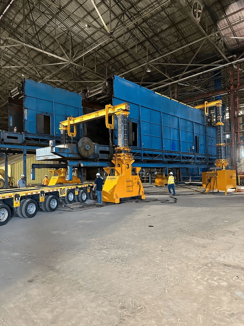 H. Brown, Inc. rigging service using hydraulic gantries and SPMTs to lower, transport, and stage five 150,000 lb. dry boxes in East Texas.