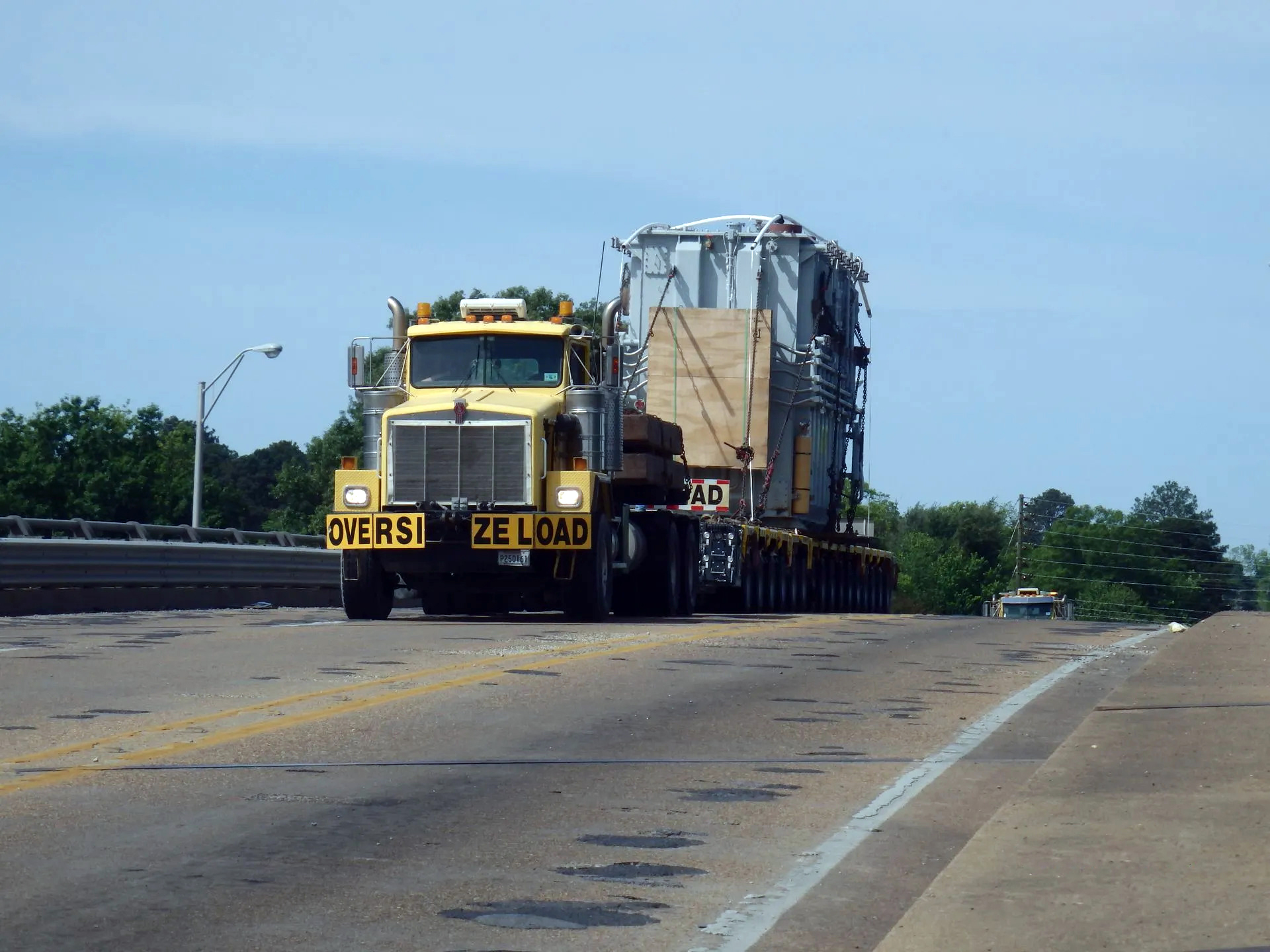 H. Brown, INc. specialized transportation service using SPMTs to cross a bridge with a transformer.